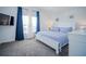 Main bedroom with king-size bed, blue and white bedding, and large windows at 2214 Wyndham Palms Way, Kissimmee, FL 34747