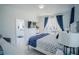Serene bedroom with king-size bed and en-suite bathroom access at 2214 Wyndham Palms Way, Kissimmee, FL 34747