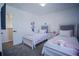 ' bedroom with twin beds, pink accents, and Minnie Mouse wall decals at 2214 Wyndham Palms Way, Kissimmee, FL 34747