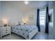 Bedroom with white furniture, blue and white bedding, and window at 2214 Wyndham Palms Way, Kissimmee, FL 34747