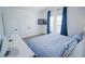 Spacious bedroom with double doors and blue bedding at 2214 Wyndham Palms Way, Kissimmee, FL 34747