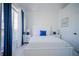 Bedroom with white furniture, blue accents, and large window with blinds at 2214 Wyndham Palms Way, Kissimmee, FL 34747