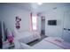 ' bedroom with twin beds, pink accents, and Minnie Mouse wall decals at 2214 Wyndham Palms Way, Kissimmee, FL 34747