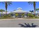 Community clubhouse with palm trees and landscaping at 2214 Wyndham Palms Way, Kissimmee, FL 34747