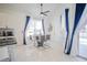 Bright dining area with glass table and blue curtains at 2214 Wyndham Palms Way, Kissimmee, FL 34747