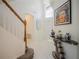 Bright and spacious entryway with a staircase, elegant mirror, and artwork at 2214 Wyndham Palms Way, Kissimmee, FL 34747