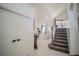 View of the entryway showcasing the staircase and a glimpse into the kitchen at 2214 Wyndham Palms Way, Kissimmee, FL 34747