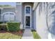 Front entrance with arched entryway and dark-colored door at 2214 Wyndham Palms Way, Kissimmee, FL 34747