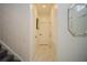 Clean hallway with white doors and tile flooring, near staircase at 2214 Wyndham Palms Way, Kissimmee, FL 34747