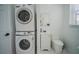 Convenient laundry area with stackable washer and dryer, and a small vanity at 2214 Wyndham Palms Way, Kissimmee, FL 34747