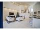 Open living room showcasing a modern aesthetic, featuring comfortable seating and a stylish media wall at 2214 Wyndham Palms Way, Kissimmee, FL 34747