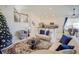 Spacious living area with a cozy atmosphere, featuring plush seating and a stunning Christmas tree at 2214 Wyndham Palms Way, Kissimmee, FL 34747
