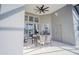 Covered patio with table and chairs near the pool at 2214 Wyndham Palms Way, Kissimmee, FL 34747