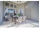 Covered patio with table and chairs near the pool at 2214 Wyndham Palms Way, Kissimmee, FL 34747
