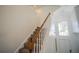 Indoor staircase with wood railing and carpeted steps at 2214 Wyndham Palms Way, Kissimmee, FL 34747