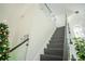 Modern staircase with glass railings and dark wood steps at 8048 King Palm Cir, Kissimmee, FL 34747