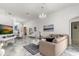 Bright living room featuring marble floors, comfy seating, and elegant chandelier at 8144 Sun Palm Dr, Kissimmee, FL 34747