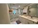 Elegant bathroom with double vanity, large shower, and a big mirror at 245 Lake Seminary Cir, Maitland, FL 32751