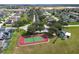 Community tennis court and surrounding homes shown from above at 344 Barbera Dr, Davenport, FL 33897