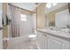 Clean bathroom with a tub, toilet, and white vanity at 344 Barbera Dr, Davenport, FL 33897