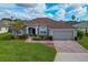 One-story home with brown roof, gray exterior, and a brick paved driveway at 344 Barbera Dr, Davenport, FL 33897