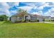 Single-story house with a large green yard and a two-car garage at 344 Barbera Dr, Davenport, FL 33897