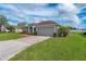 One story house with a large front yard and paver driveway at 344 Barbera Dr, Davenport, FL 33897