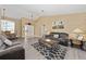 Spacious living room with gray couches, coffee table, and wood-look floors at 344 Barbera Dr, Davenport, FL 33897