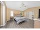 Main bedroom with a bed, nightstand and gray laminate floors at 344 Barbera Dr, Davenport, FL 33897