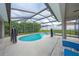 Screened pool and spa with lounge chairs at 344 Barbera Dr, Davenport, FL 33897