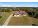 Property showcasing a house with a spacious backyard and a long driveway at 10181 Sw 46 Ct, Ocala, FL 34476