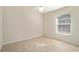 Simple bedroom with tile flooring and window with blinds at 10181 Sw 46 Ct, Ocala, FL 34476