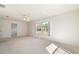 Spacious living area with large window and carpeted floors at 10181 Sw 46 Ct, Ocala, FL 34476