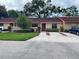 Tan, two-story condo with red tile roof and landscaping at 1915 Sw 34Th Court Ct, Ocala, FL 34474