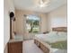 Spacious bedroom with a comfortable bed, large window, and wicker dresser at 17846 Se 125Th Cir, Summerfield, FL 34491