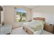 Bright bedroom featuring a large window, a double bed, and a wicker dresser at 17846 Se 125Th Cir, Summerfield, FL 34491