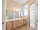 Bathroom with double vanity, large mirror, and shower at 17846 Se 125Th Cir, Summerfield, FL 34491