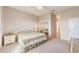 Main bedroom with king bed, mirrored closet, and access to another room at 17846 Se 125Th Cir, Summerfield, FL 34491
