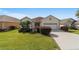 Single-story house with two-car garage and well-manicured lawn at 17846 Se 125Th Cir, Summerfield, FL 34491
