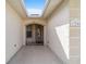 Inviting entryway with light-colored walls and a charming arched entry door at 17846 Se 125Th Cir, Summerfield, FL 34491