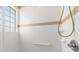 Clean shower with tiled walls and safety bar at 17846 Se 125Th Cir, Summerfield, FL 34491