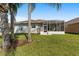 Home with a screened-in lanai and palm trees at 17846 Se 125Th Cir, Summerfield, FL 34491