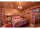 Bedroom with wood walls and a metal bed frame at 22649, 22645 And Tbd Ne 105Th Avenue Rd, Fort Mc Coy, FL 32134