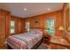 Cozy bedroom with wood-paneled walls and a comfortable bed at 22649, 22645 And Tbd Ne 105Th Avenue Rd, Fort Mc Coy, FL 32134