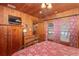 Bedroom with wood walls, metal bed frame and lake view at 22649, 22645 And Tbd Ne 105Th Avenue Rd, Fort Mc Coy, FL 32134