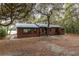 Brown house exterior with a walkway and tree-lined surroundings at 22649, 22645 And Tbd Ne 105Th Avenue Rd, Fort Mc Coy, FL 32134