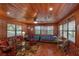 Living room with wood walls, twin beds and a wood floor at 22649, 22645 And Tbd Ne 105Th Avenue Rd, Fort Mc Coy, FL 32134