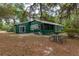 Green house exterior with a screened porch and backyard at 22649, 22645 And Tbd Ne 105Th Avenue Rd, Fort Mc Coy, FL 32134