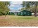 Charming green house with white trim and metal roof at 22649, 22645 And Tbd Ne 105Th Avenue Rd, Fort Mc Coy, FL 32134