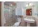 Clean bathroom with a pedestal sink, shower, and white cabinets at 22649, 22645 And Tbd Ne 105Th Avenue Rd, Fort Mc Coy, FL 32134